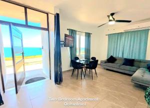 a living room with a couch and a table and chairs at Ocean Front Apartments in Arecibo