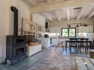 a kitchen and living room with a stove and a table at Chalupa Jesenka in Sobotín