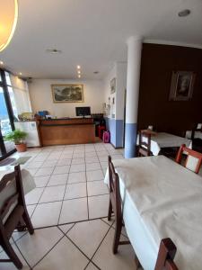 a hotel room with a bed and a waiting room at Hotel Antartida Argentina in Ushuaia