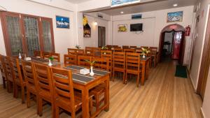 a dining room with wooden tables and chairs at Hotel Yatri in Pokhara