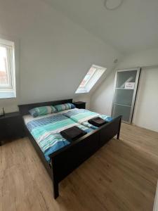 a bedroom with a bed in a room with windows at Ferienwohnung Maichingen in Sindelfingen