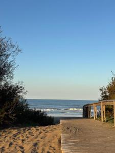 a wooden path to the beach with the ocean at Beach House and Nature in Aguas Verdes