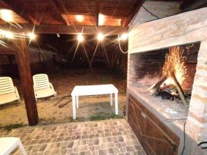 a patio with a fireplace and a table and chairs at Beach House and Nature in Aguas Verdes +7 photos
