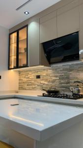 a kitchen with a white counter top and a stove at Aklass Apartments in Lekki