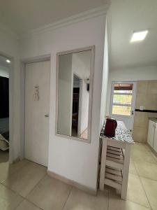 a room with a mirror and a table with a stool at Beach House and Nature in Aguas Verdes