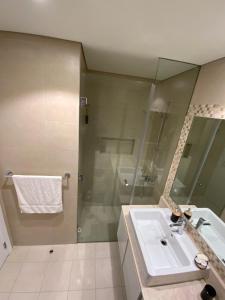 a bathroom with a sink and a shower at Nuchi studio in Dubai +17 photos