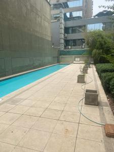 a swimming pool in a building with a building at Monica Canales in Santiago