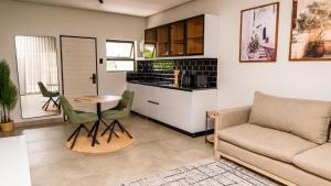 a living room with a couch and a table at Villa On 59 in Giyani