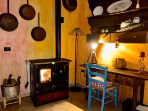a room with a stove and a table and a chair at Locanda D'Ogliastra in Triei +95 photos