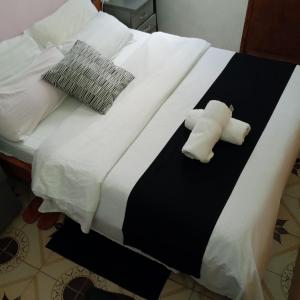 a bed with two rolled up towels on it at Accomodation bnb in Ruiru +2 photos