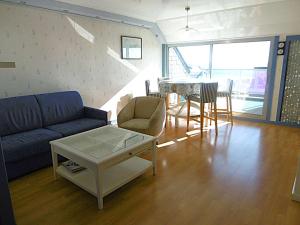 a living room with a couch and a table at Appartement 4 à 6 personnes avec vue mer - GWENAEL in Sarzeau +11 photos