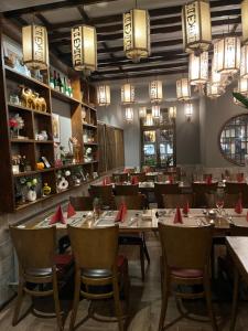 a restaurant with tables and chairs with red napkins on them at Trang Hotel Rastatt in Rastatt