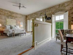 a living room with a bed and a couch at Riverview Penthouse in Savannah +29 photos