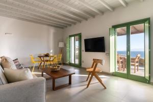a living room with a couch and a table at Villa Altheon Mykonos in Mykonos