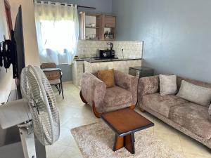 a living room with a couch and a table at Aurora two in Kampala