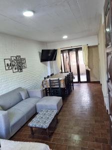 a living room with a couch and a table at Duplex en mar de ajo Olivia in Mar de Ajó