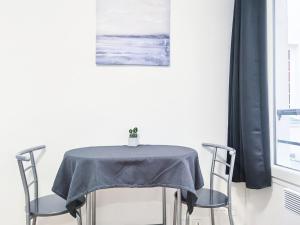 a table with two chairs with a blue table cloth on it at Studio Near Metro & Marais & Hotel de Ville & Seine in Paris