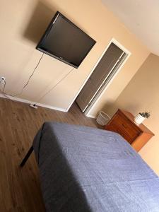 a bedroom with a flat screen tv on the wall at West Valley Spacious Room 2 94th in Phoenix