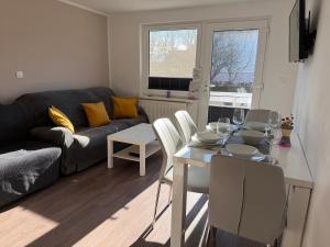 a living room with a table and a couch at Apartments Mici in Bled