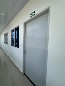 a white garage door with the number on it at Fantastico Apto 2 Hab con Parqueo in Montería
