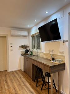 una cucina con scrivania e TV a parete di The Colony - By Lime Luxe a Haifa