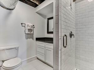 a white bathroom with a toilet and a shower at Riverview Terrace in Savannah +24 photos