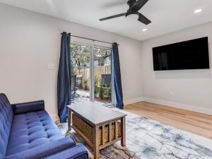 a living room with a blue couch and a tv at Lazy Hammock in Tybee Island