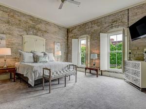 a bedroom with a bed and a brick wall at Riverview Estate in Savannah