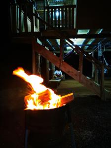 a fire pit in front of a tent at night at Rancho Alto Túcan in Buenos Aires