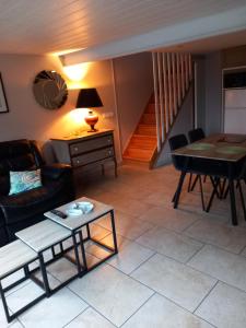 a living room with a couch and a table at Maison de Lily in Cier-de-Luchon