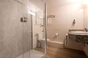 a bathroom with a shower and a toilet and a sink at Hotel Cervol by Nexta in Andorra la Vella
