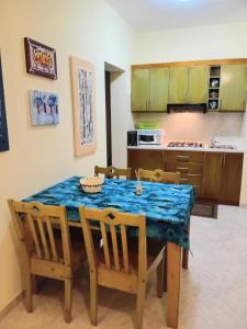 萨尔雷Sal Rei Apartments, Boa Vista的厨房配有桌椅和蓝桌布