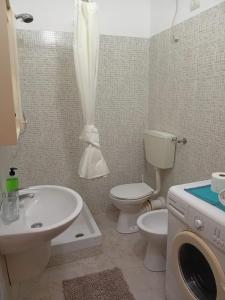 萨尔雷Sal Rei Apartments, Boa Vista的配有水槽马桶和洗衣机的浴室 更多80张照片