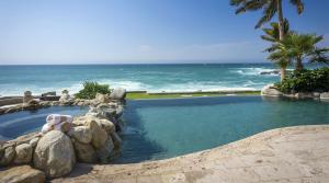 a swimming pool with the ocean in the background at Casa Edwards II in San José del Cabo