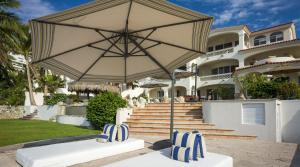 a large white umbrella in front of a house at Casa Edwards II in San José del Cabo