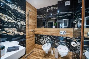 a bathroom with two sinks and a toilet and a shower at Best Central Lux Studio in Bansko +31 photos