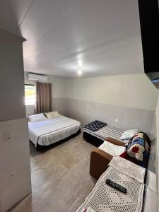 Ένα ή περισσότερα κρεβάτια σε δωμάτιο στο Pousada Patuzzi