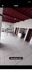 a large room with a table and a tiled floor at Área de Itans in Caicó