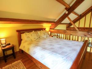 a bedroom with a large bed in a attic at Maggie's Barn in Talgarth