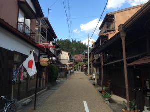 an empty street with a flag on a building at Takayama Ninja House in Takayama