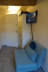 a living room with a blue couch and a flat screen tv at La Gritta in Lerici +17 photos