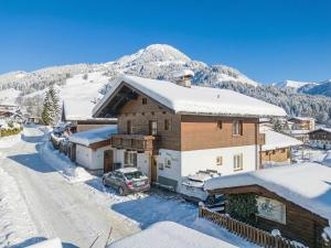 a house with a car parked in the snow at Haus David in Kirchberg in Tirol
