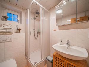a white bathroom with a sink and a shower at Haus David in Kirchberg in Tirol +19 photos
