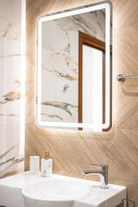 a bathroom with a sink and a mirror at Best Central Lux Studio in Bansko +27 photos