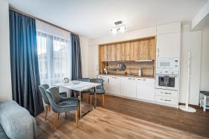 a kitchen with a table and chairs in a room at Best Central Lux Studio in Bansko