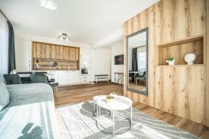 a living room with a couch and a table at Best Central Lux Studio in Bansko