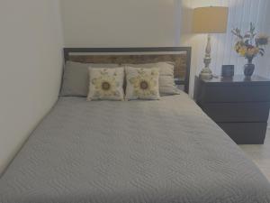 a bedroom with a large bed with two pillows at Cozy 2-Bed Guest Room Convenient Location in Tracy