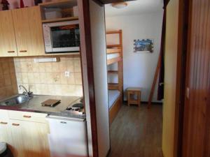 a small kitchen with a sink and a stove at Studio central au Praz de Lys, 4 pers, proche pistes - FR-1-815-18 in Le Praz de Lys