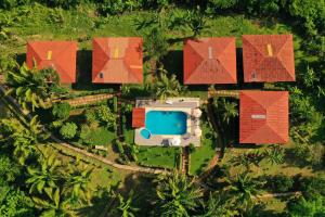 an overhead view of a house with red roofs and a pool at Monte Amazonico Lodge in Tambopata +33 photos