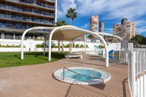 a patio with a hot tub and a pavilion at Sanset Waves with a sea view! in Benidorm
